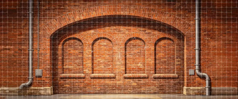 Rustic red brick arch wall stage backdrop with recessed masonry arches and pipes for urban theatre, school musicals, dance recitals and industrial scenes.