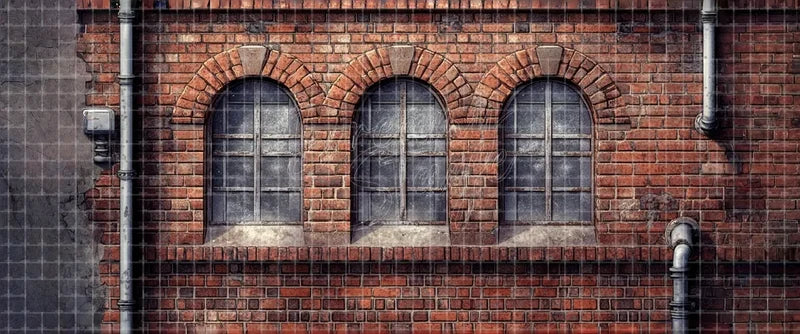 Industrial brick wall stage backdrop with three arched factory windows and drainpipes for school musicals, urban theatre, ballet and dance recitals.